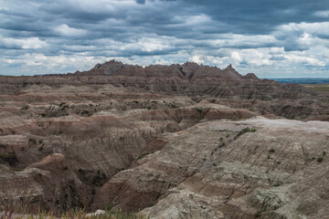 low cotton like summer clouds covering the sky in Badlands National Park in South Dakota.