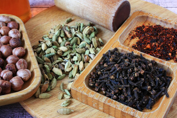 Grains of cardamom, clove buds and nuts