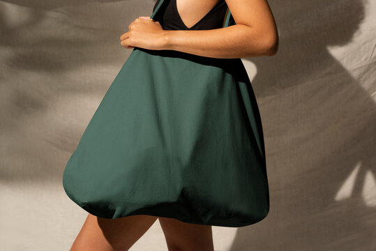 Woman carrying green tote bag accessory studio shoot