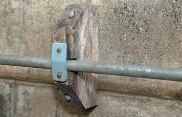 Pipe bracket made of wood