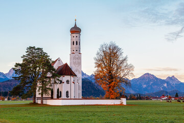Beautiful view of the Saint Coloman church near the Neuschwanstein castle, against the backdrop of the beautiful mountains, Schwangau in the Bavarian province