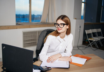 Business woman in white shirt at work tables documents office official