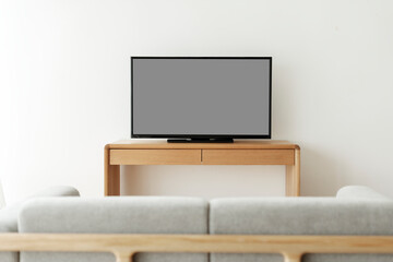 Blank black smart TV screen on a wooden table
