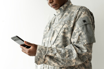 Female soldier using on a smartphone communication technology