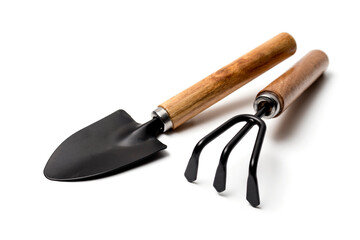 Garden accessories on a white background. Garden rake and shovel. Conception of agriculture, horticulture, processing of homesteads, growing vegetables in the garden and greenhouse