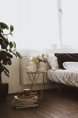 Laptop computer in grey crumpled bed with linens, pillows against grey wall. Freelancer,...