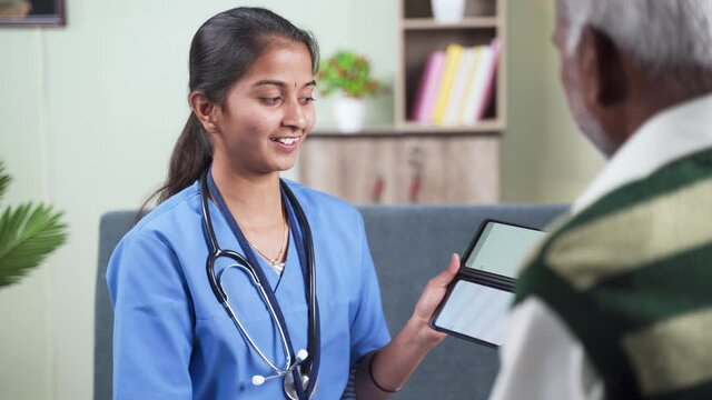Shoulder shot of old man,Doctor or nurse explaining to patient about health details by using mobile app on phone during home visit.