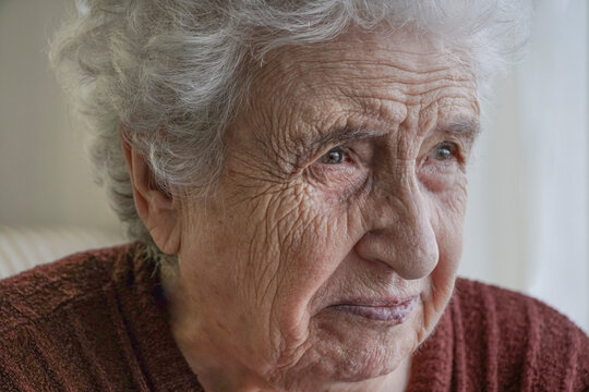closeup wrinkled face of a sad old woman