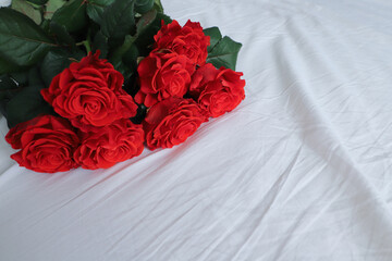 a bouquet of red roses on a white sheet to use as a background