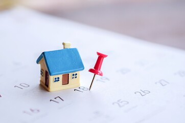 house model and red pin mark on calendar, due date for home payment ,property reminder concept