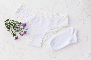 Beautiful women cotton panties and women socks on white background.