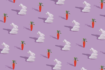 Pattern with white rabbit and orange carrot on violet background.