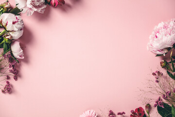 Assorted pink flower border on pink background, flat lay