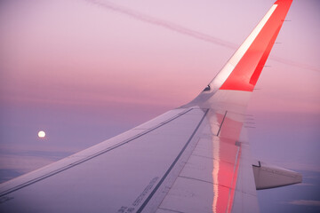 Beautiful sunset, airplane flying view from inside window aircraft of Traveling