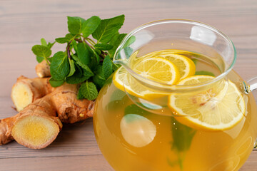 Glass teapot of tea with ginger and citrus