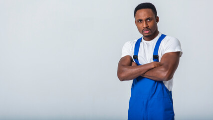portrait of a delivery man wearing a white t-shirt and blue pants. Isolated on a white background. Concept of delivery, mail, shipment, loader, courier, human labor. Sign language