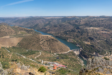 Aerial view from Penedo Durao viewpoint, typical landscape of the International Douro Park, dam on Douro river and highlands in the north of Portugal, Spain mountains as background