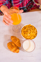 Healthy lifestyle, orange juice for breakfast, milk and cereals with skittles