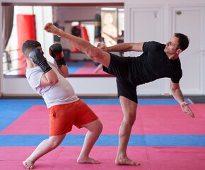 Fototapeta na wymiar Overweight kickboxer sparring with his partner