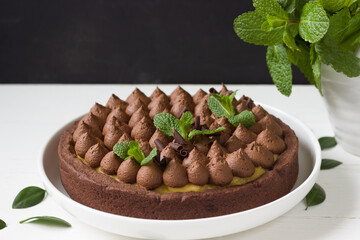 Chocolate tart with lemon curd and fresh mint leaves.Chocolate pie. Chocolate cake