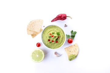 Bowl of guacamole and nachos isolated on white background.  Top view.