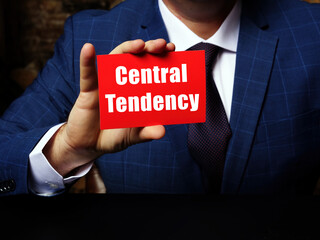 Businessman holding a blank business card. Business concept about Central Tendency with phrase on the sheet.