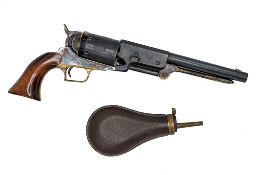 Barcelona, Spain; January 7, 2021: muzzle-loading revolver pistol are its original leather powder case on white background