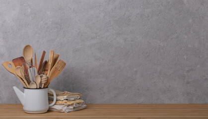 Kitchen tools, utensils and kitchenware on the table on a grey concrete background. Selective focus.