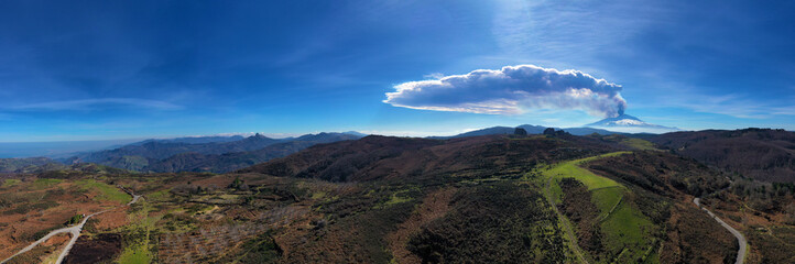 Virtual reality panorama at 180 degrees of the eruption of the Etna volcano by day 19 February 2021 seen from the megalithic complex of Argimusco near Montalbano Elicona. Paroxysm on Etna in Sicily. 