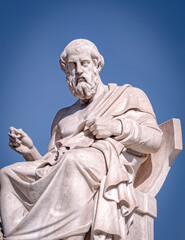 Plato the ancient Greek philosopher and thinker white marble statue under blue sky, Athens Greece