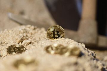 Financial background with bitcoin coins on the ground of a mine with background tool, conceptual.