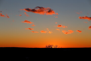 Obraz na płótnie Canvas bright orange sky with clouds at sunset