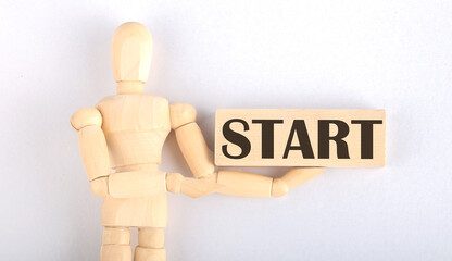 Wooden man shows with a hand to block with text START