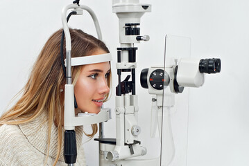 The doctor checks the patient's throat. Consultant in the ophthalmology office. Apparatus for...