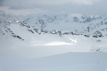 Caucasus mountains and glaciers in cloudy cloudy weather in the evening. Calm not colorful landscape