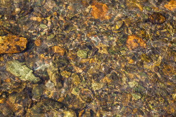 Natural background, the stones at the bottom of the creek. Clean stream.