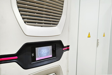 White big industrial conditioner on a door of electric equipment cabinet in automatic control room in a factory.