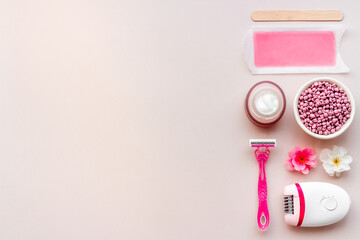 Epilation concept. Set of epilator with wax strips and razor, flat lay