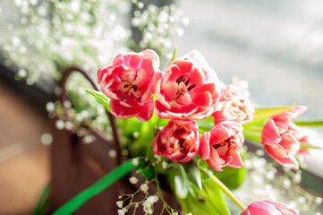 Bright pink tulips in the bag. A gift for a woman. Selective focus. Bright background for your desktop.