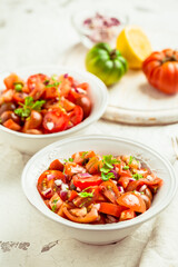 Mexican Pico de Gallo with ingredients - tomato salad with onion, parsley, coriander