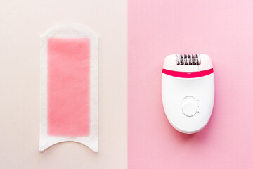 Epilator with pink wax strips. Epilation concept. Top view, flat lay