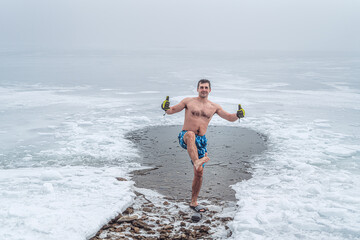 Winter swimming. Man in an ice-hole.
