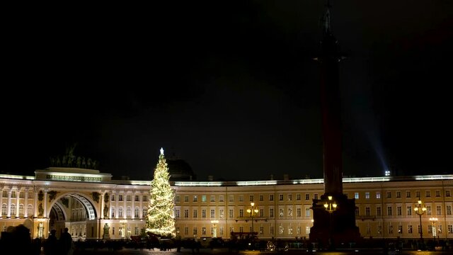 Saint-Petersburg, Russia - December 19 of 2020: residents of the city walking in the evening along the decorated square of the Palace Square. Video in 4k.