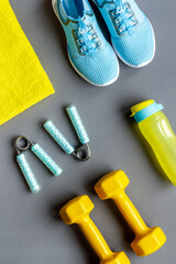 Fototapeta na wymiar Top view of fitness accessories with dumbbells and sneakers