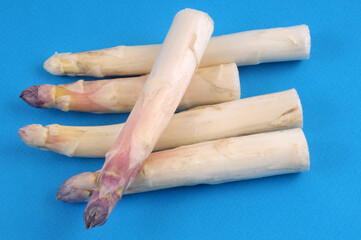 Asperges blanches en gros plan sur fond bleu