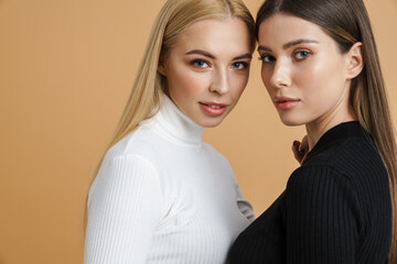 Beautiful two women posing head to head on camera