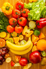 Fruits and vegetables on wood desk. Vertical photo.