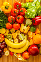 Obraz na płótnie Canvas Fruits and vegetables on wood desk. Vertical photo.