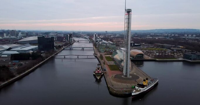 Aerial shot of Glasgow science centre along river clyde with bridges in background