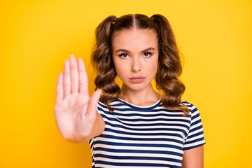 Portrait of attractive strict serious girl showing palm stop sign dont move caution isolated on...